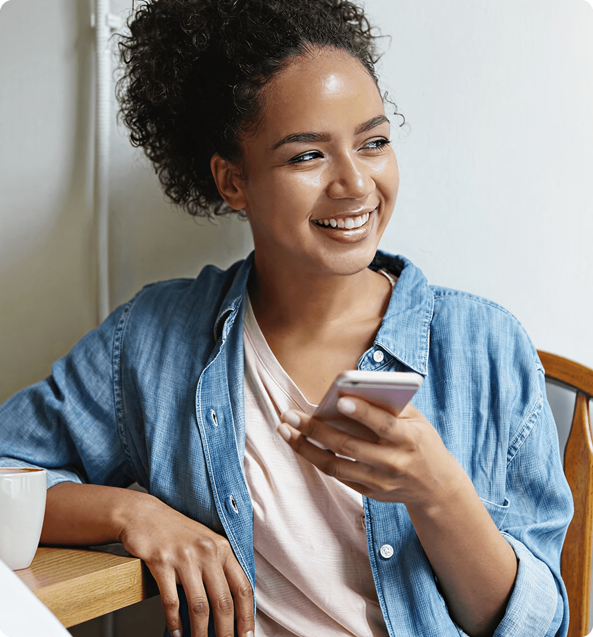 Lisa, a SureBright customer, smiling with her phone